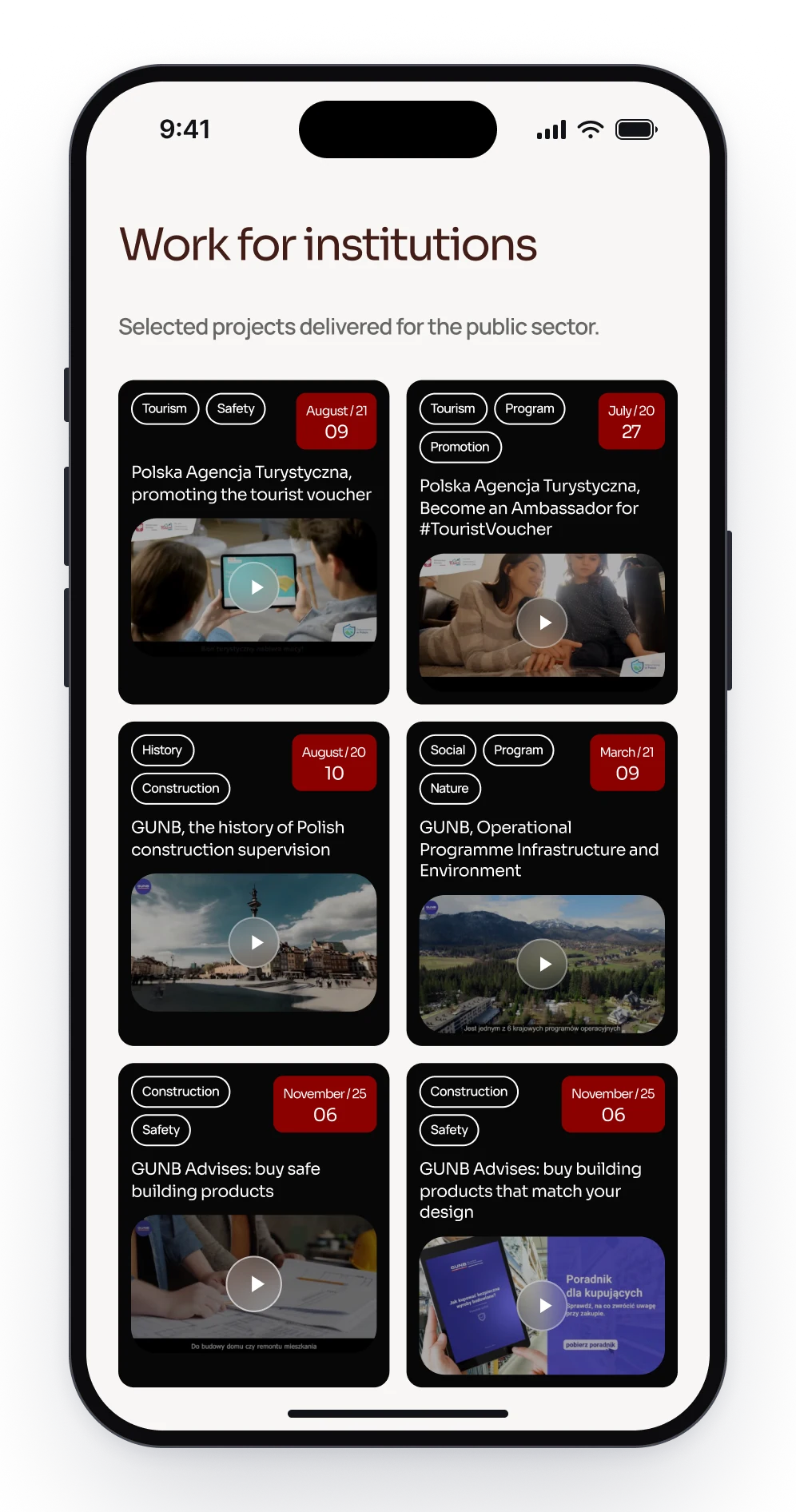 Work for institutions on a phone, six dark project cards in two columns, each with tags, a date and a video poster